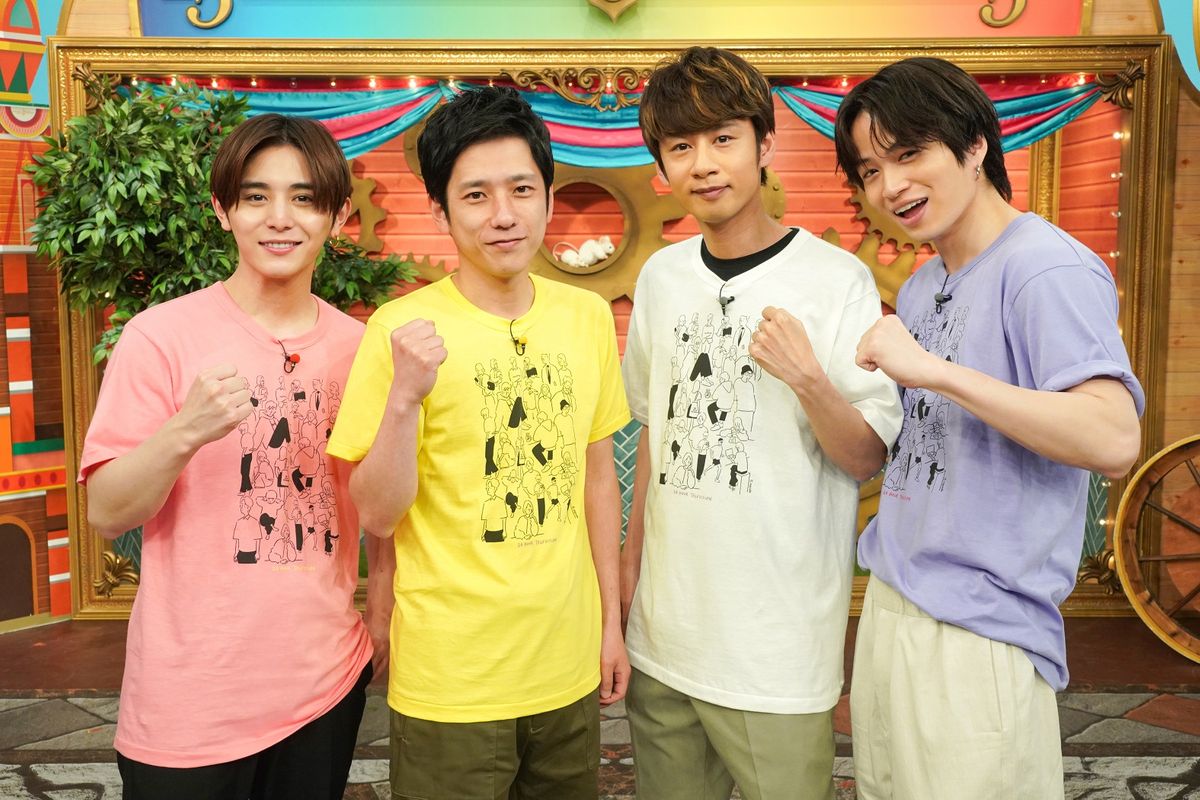 Tシャツを着る（左から）山田さん、二宮さん、中丸さん、菊池さん