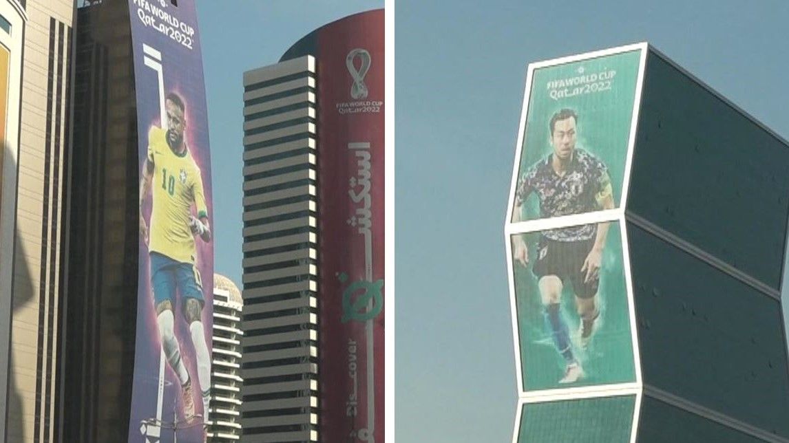 高層ビルに貼られた選手のポスター(左:ネイマール選手、右:吉田麻也選手)