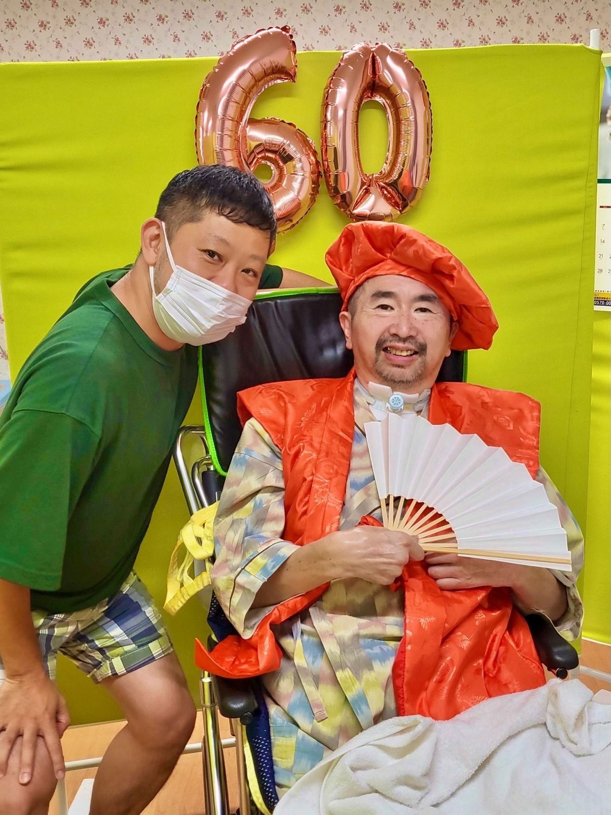 病院内でタカシさん（写真右）の還暦を祝うマサノリさん（左）